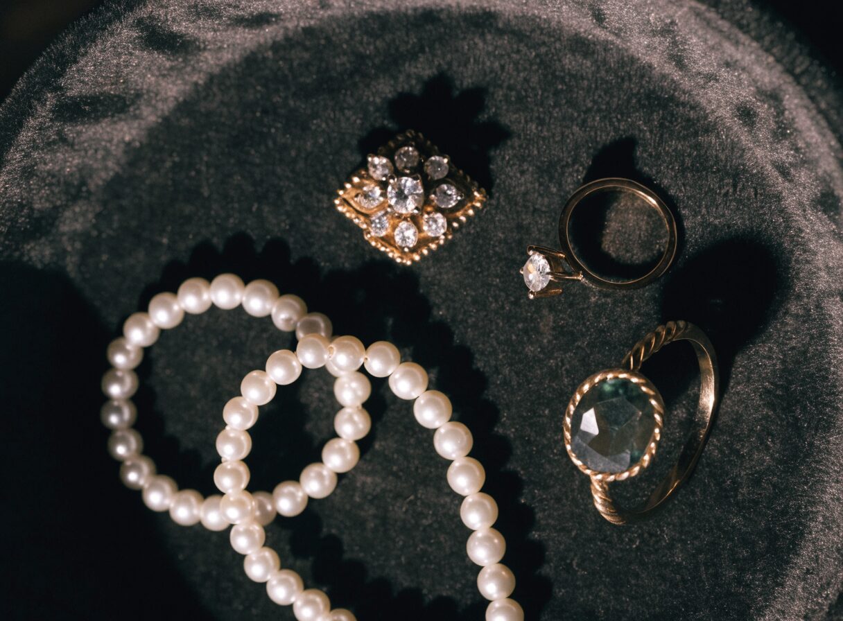 Estate jewelry including a brooch, pearls and rings, representative of the jewelry we handle